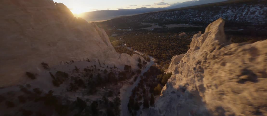 Mountains valleys and trees sit under the bright sun