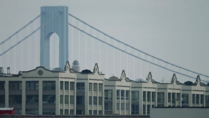 Heat wave distortion of suspension bridge behind buildings