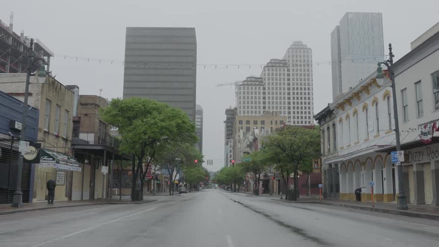 An empty street with no traffic outside of a large city