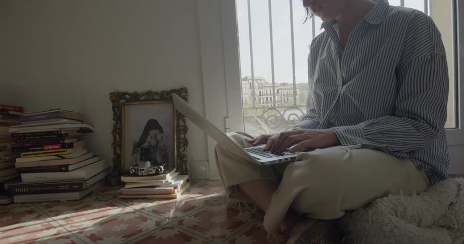 A woman typing on a laptop