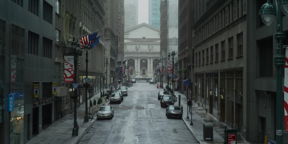 A street in the shadow of skyscrapers in an american city leading towards a courthouse