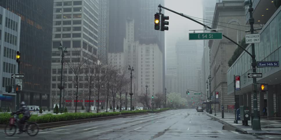 Fog hangs over a nearly empty metro city street