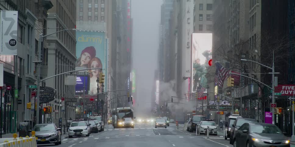 Cars drive down a city street