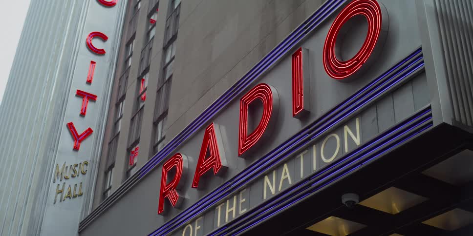 A lit up sign on the side of a building