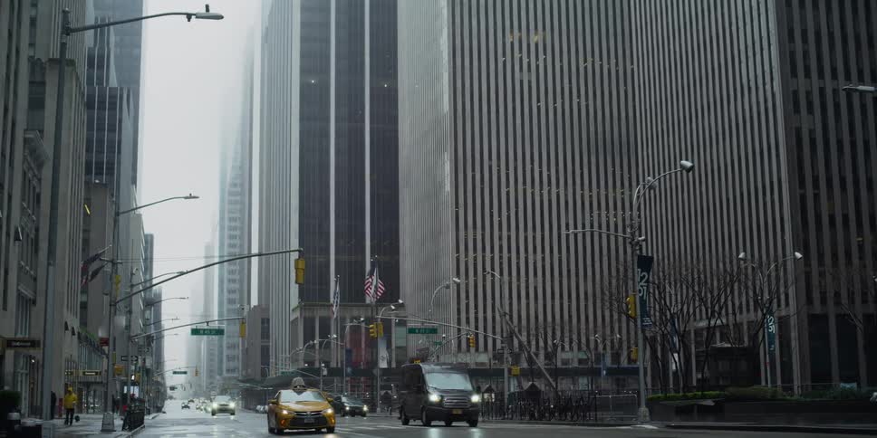 A city street with vehicles and buildings in the background