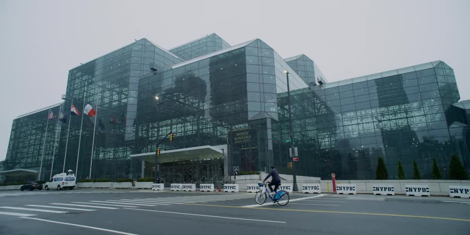 A person rides a bike down a quiet city street