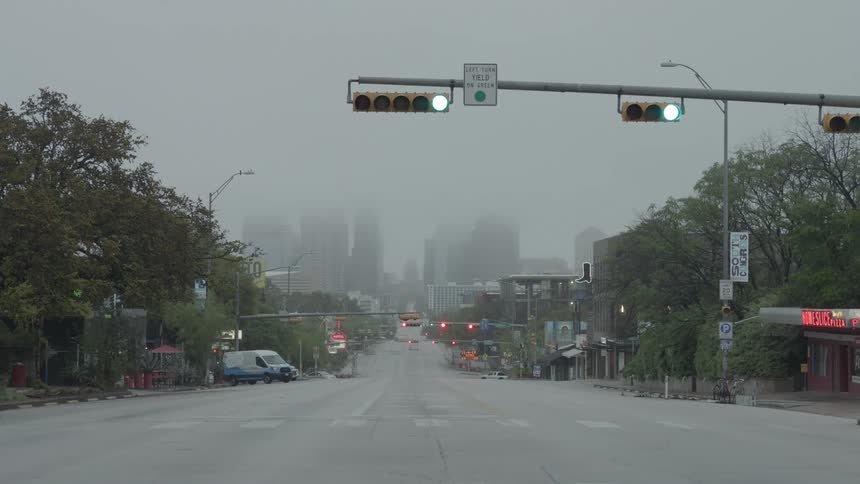 Traffic lights change color on a deserted city street