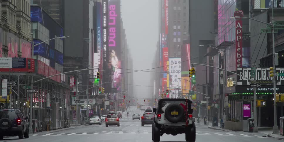 Cars driving through nearly empty new york streets during pandemic
