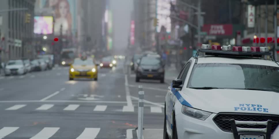 Cars drive down a city street