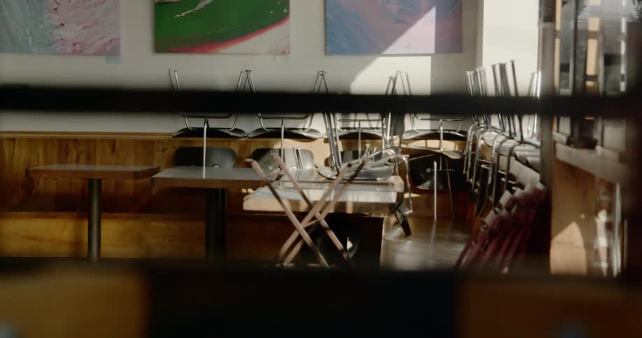Closed restaurant with chairs over tables