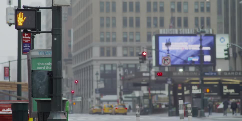 Cars drive on a busy city street