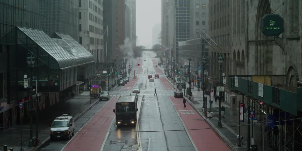 Light traffic on city street in manhattan in the rain