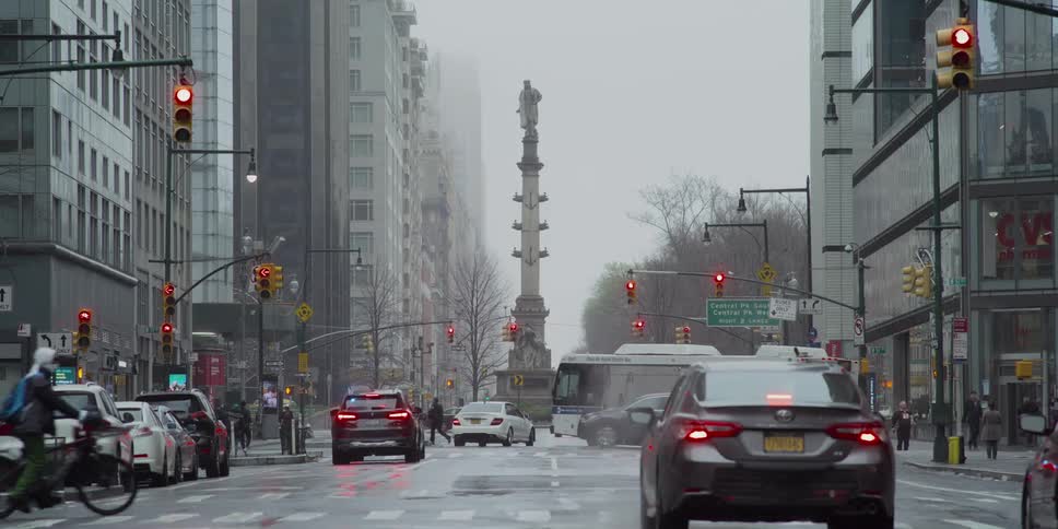A busy intersection in the city on a rainy day