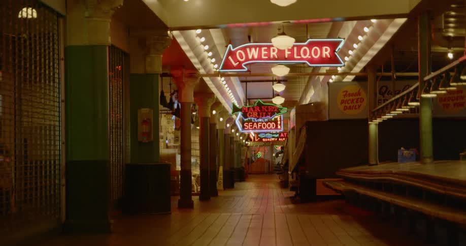 Empty open air market with neon signs at night