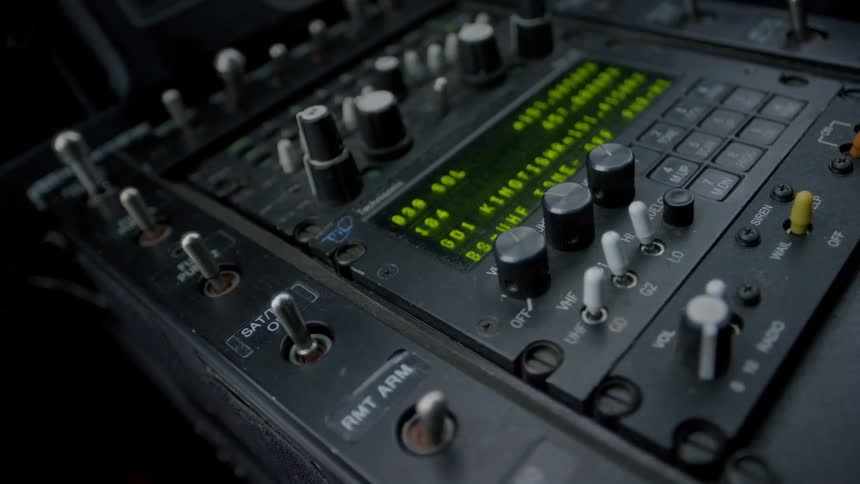 Close up of switches and dials on electronic equipment in a helicopter