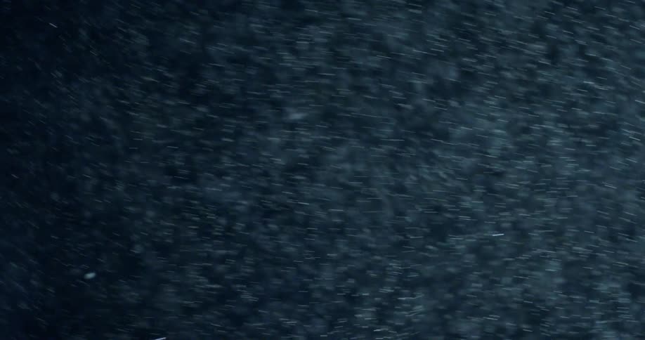 Particles of dust or snow float in the air