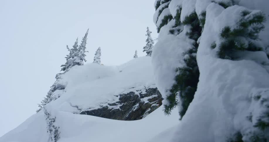 A man jumps off a cliff on skis