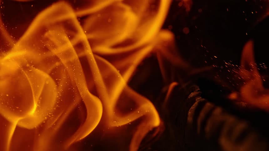 Flames rise off of burning wood
