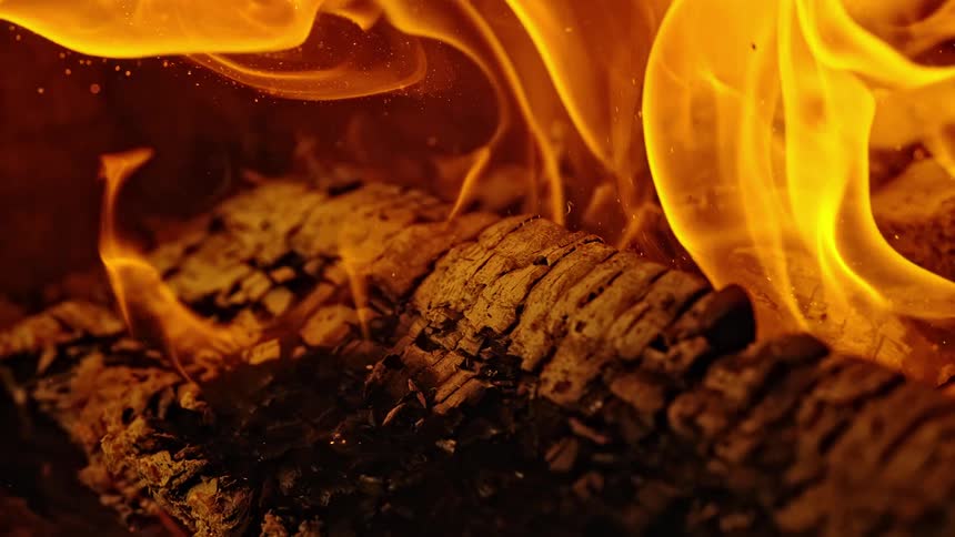 Fire burning on pieces of wood on fireplace