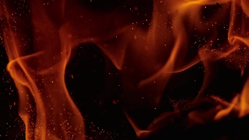 Flames in slow motion against black background