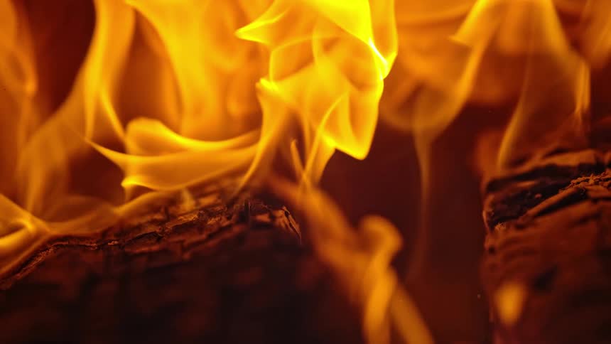 Flames rise from pieces of burning wood