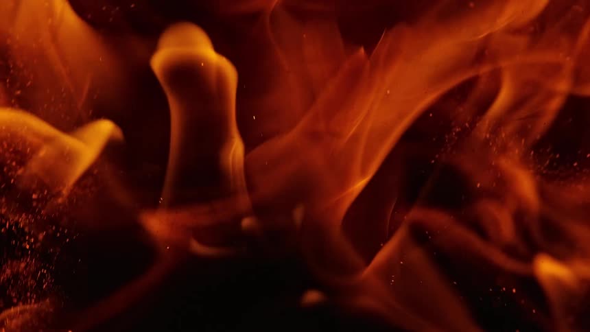 Orange smoke rises from a fire