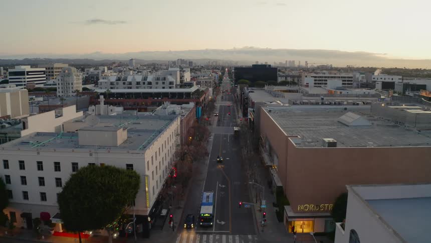 Drone footage of light traffic on city street