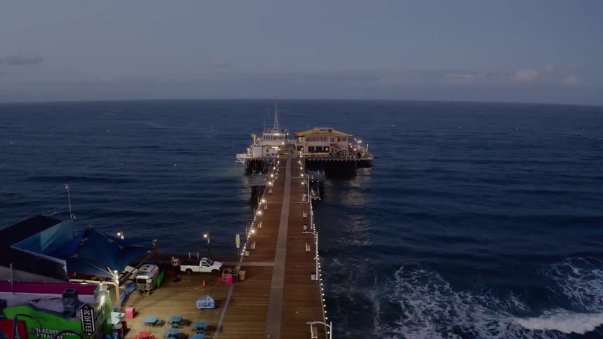 Aerial view of boardwalk pier at sunset
