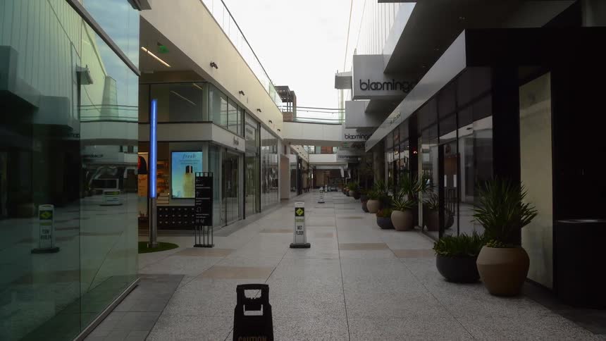 Empty sidewalk in deserted shopping center