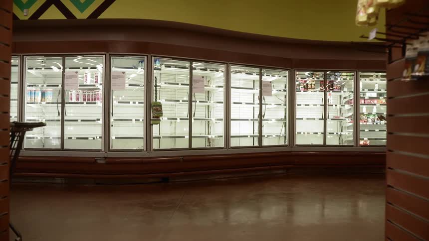 Empty shelves are shown in a grocery store