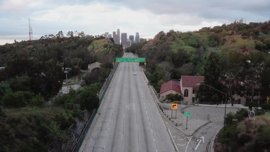 Cars driving down a freeway towards a city