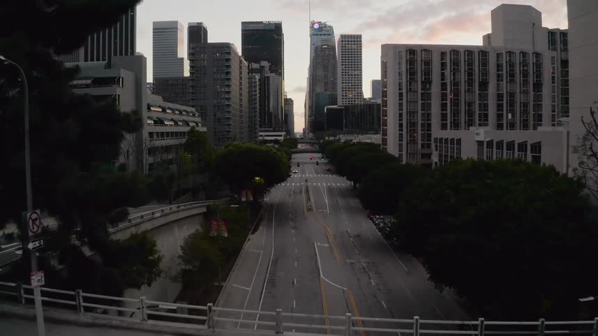 Aerial of empty streets in downtown metropolis area at sunrise