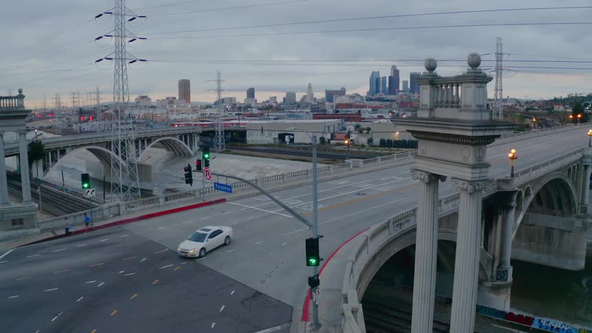 A bridge sits above train tracks near downtown