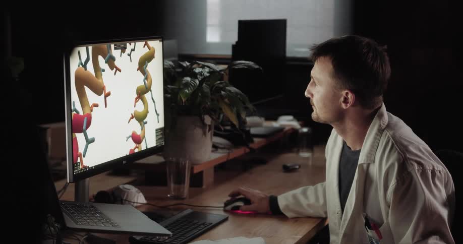 Doctor sitting at the desk uses desktop in the office