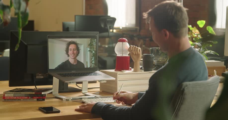 Two men having a video conference call in an office