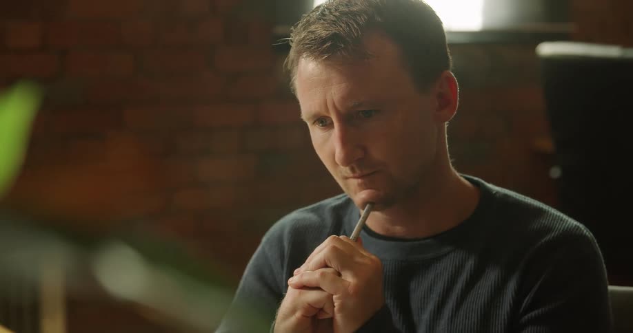 A man converses with another person via a computer