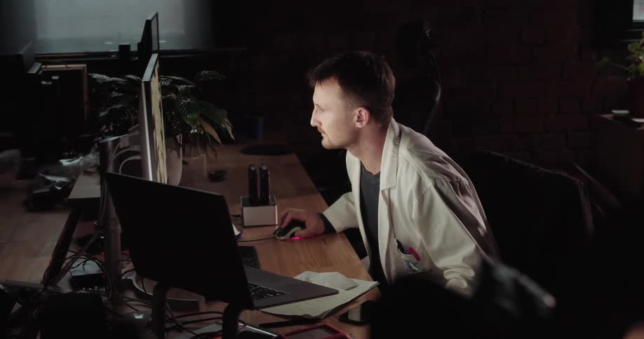 A doctor takes a closer look at his computer screen