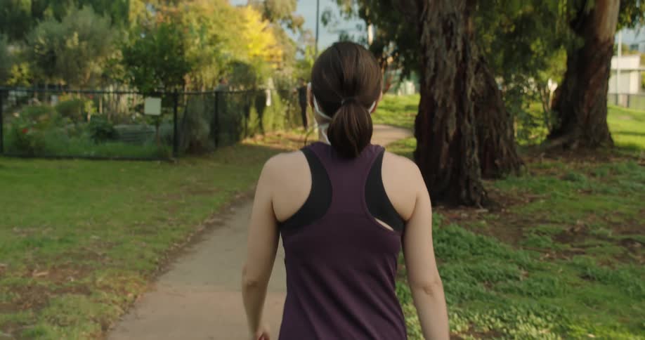 A young woman walks along a path outside
