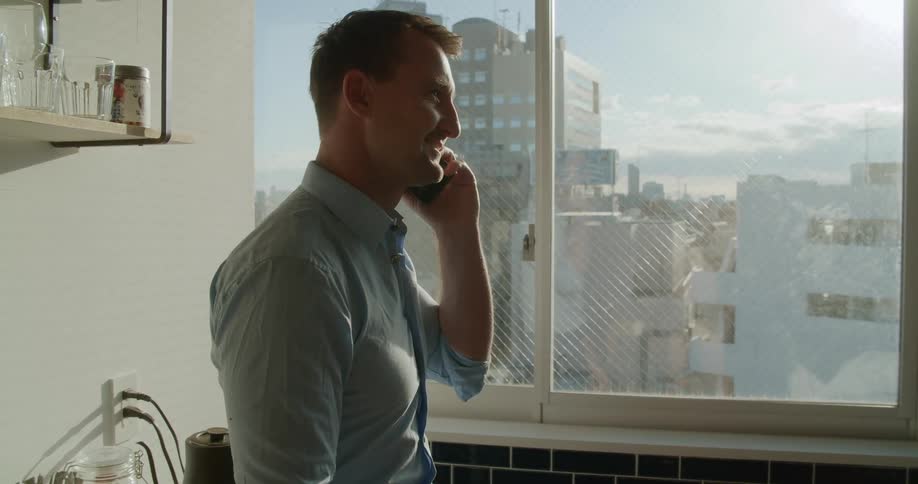 A person is talking on a cellphone indoors