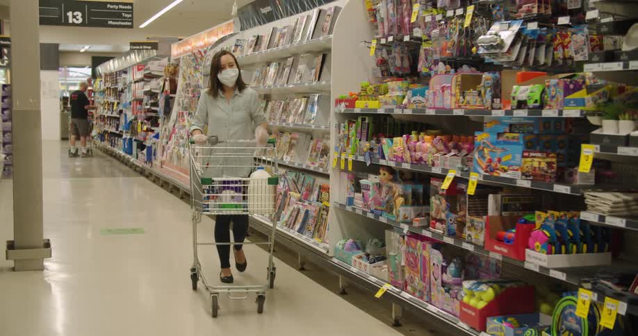 A woman is wearing a face mask and shopping in a store