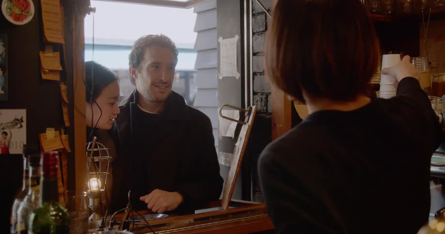 Couple ordering coffee at drive up window in a coffee shop