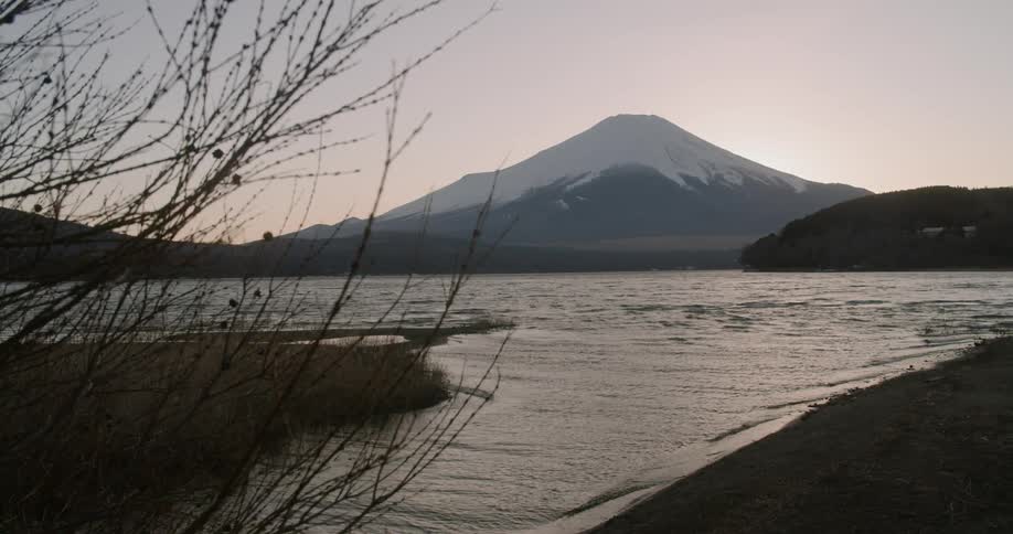 A lake sits in front of a volcano