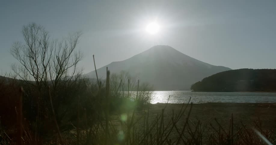 The sun glows in the sky above mount fuji in japan