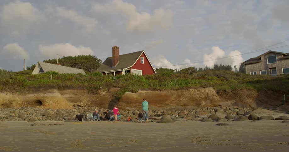People gather on a rocky beach