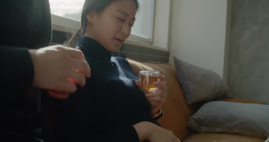 A woman sits on a laptop