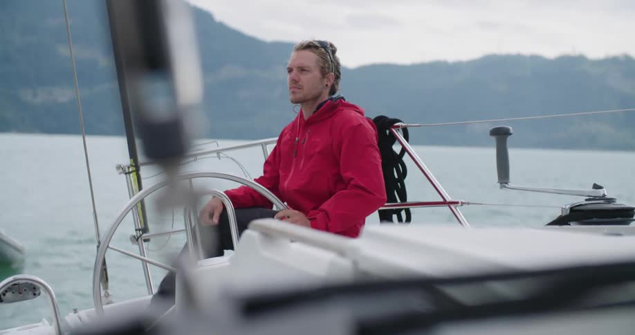 A man sits on a boat peacefully in the lake water