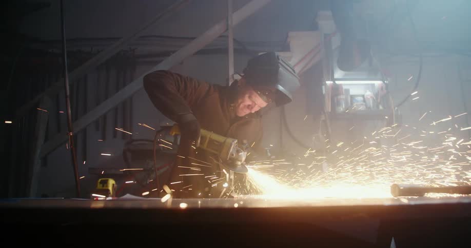 A man in a shop welds
