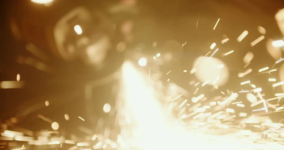 Sparks fly as person grinds metal with power tool