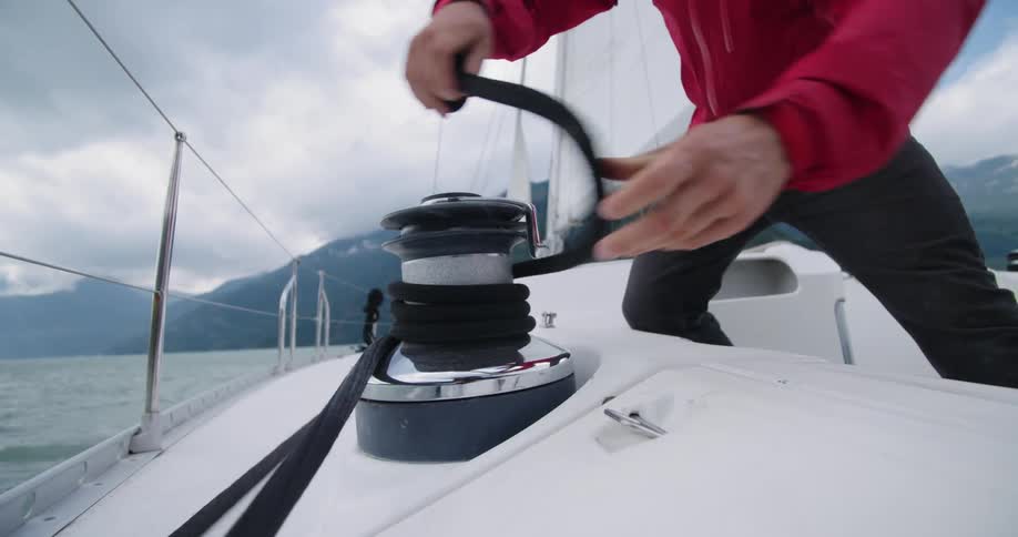 A man is standing on a boat that is on water