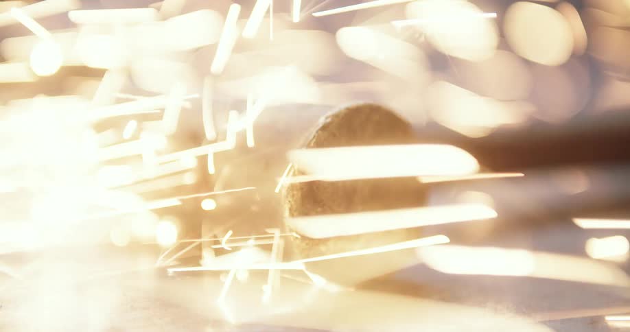 Metal hammer atop an anvil showered with sparks